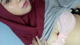 Indian girl in hijab reveals her breasts and engages in sexual activity