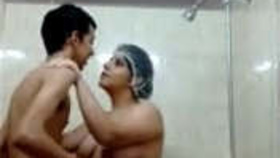 Aunty with large breasts gets oral pleasure from fortunate young man in the shower