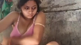 A young wife from the village bathes in the shower