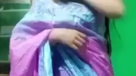 A stunning Indian woman removes her traditional sari and displays herself