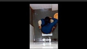 An Indian woman swaps out a sanitary product in the restroom