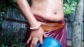 Indian wife bathes outdoors and reveals her breasts