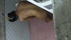 An Indian woman takes a bath