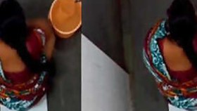 XXX girl pulls her sari up to piss and wash sex opening in the loo