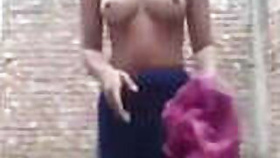 Indian village girl takes a brinjal